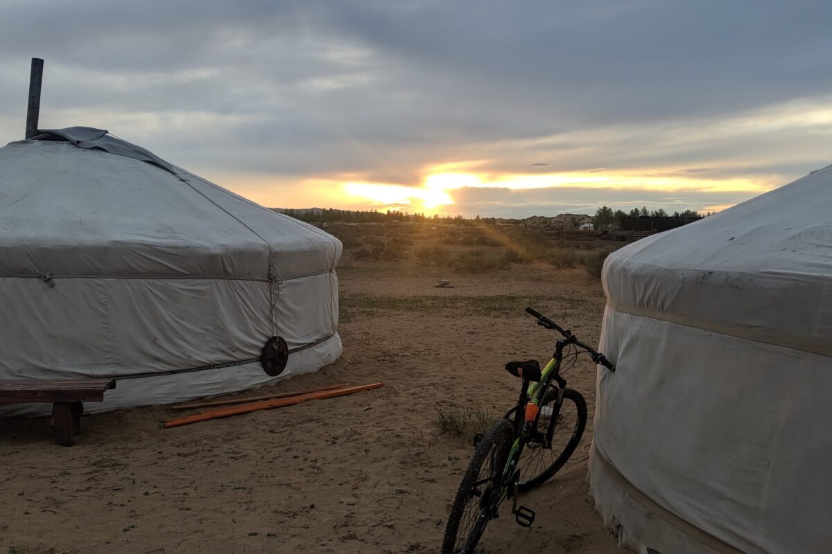Two gers at sunset with a mountain bike leaning against one of them