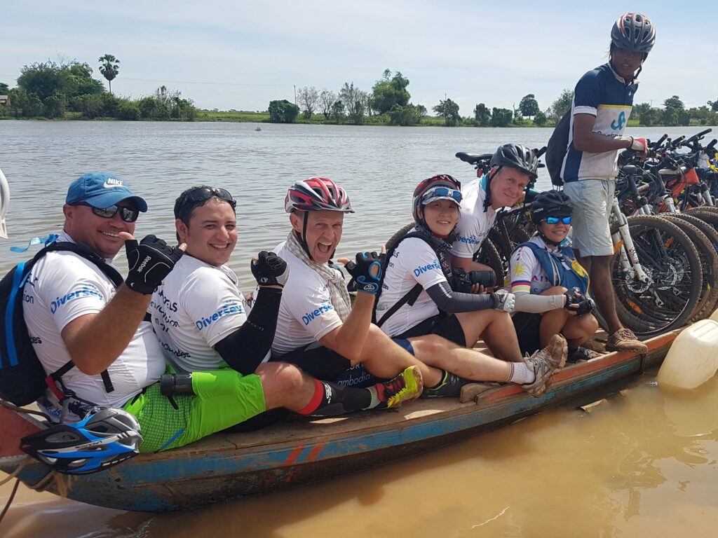 Riders and a row of bikes on a wooden boat, Cambodia, November 2017