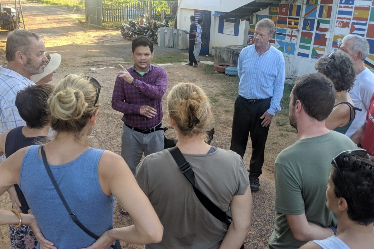 A member of the Sustainable Cambodia team talks with the group in Pursat