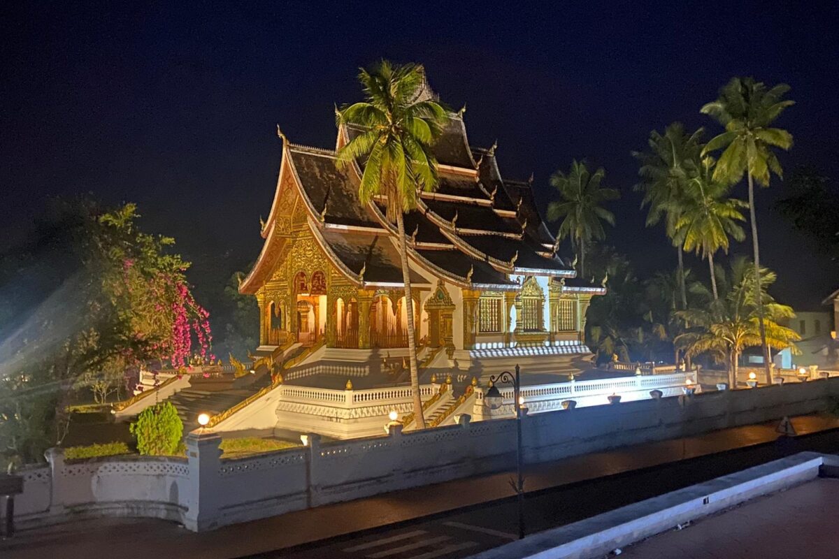 A gilded Luang Prabang temple lit up at night