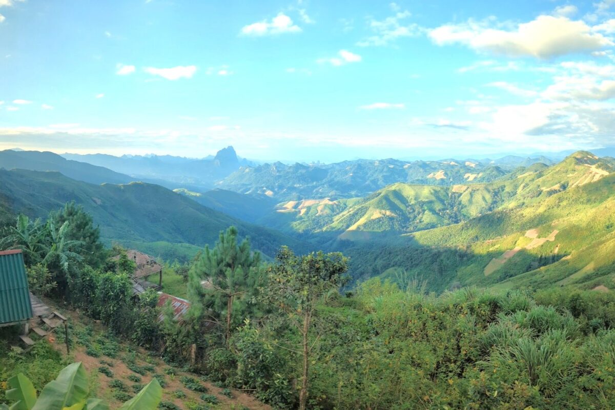Sunlit ridges and a lone karst peak from the Phou Khoun camp