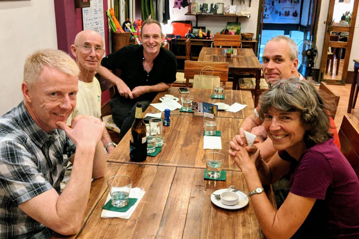 Riders around a dinner table in Luang Prabang