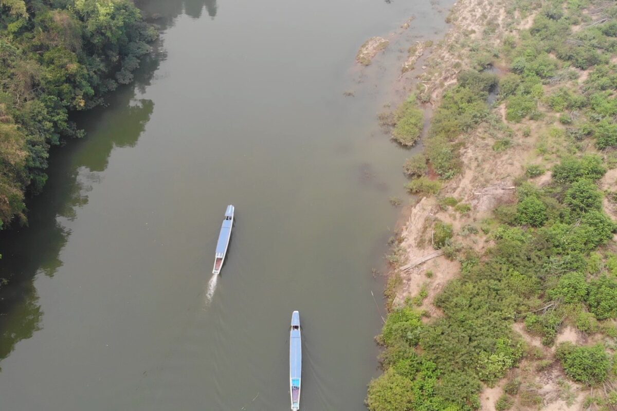 From the air: two long-tail boats on a green river